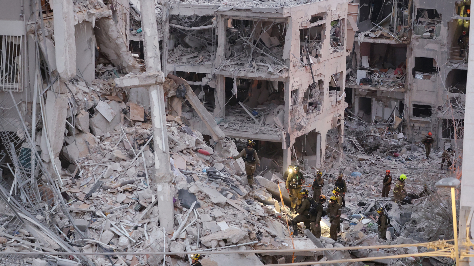 Responders amid rubble after an Iranian missile hit Bat Yam, near Tel Aviv, June 15, 2025. (Photo: AFP)