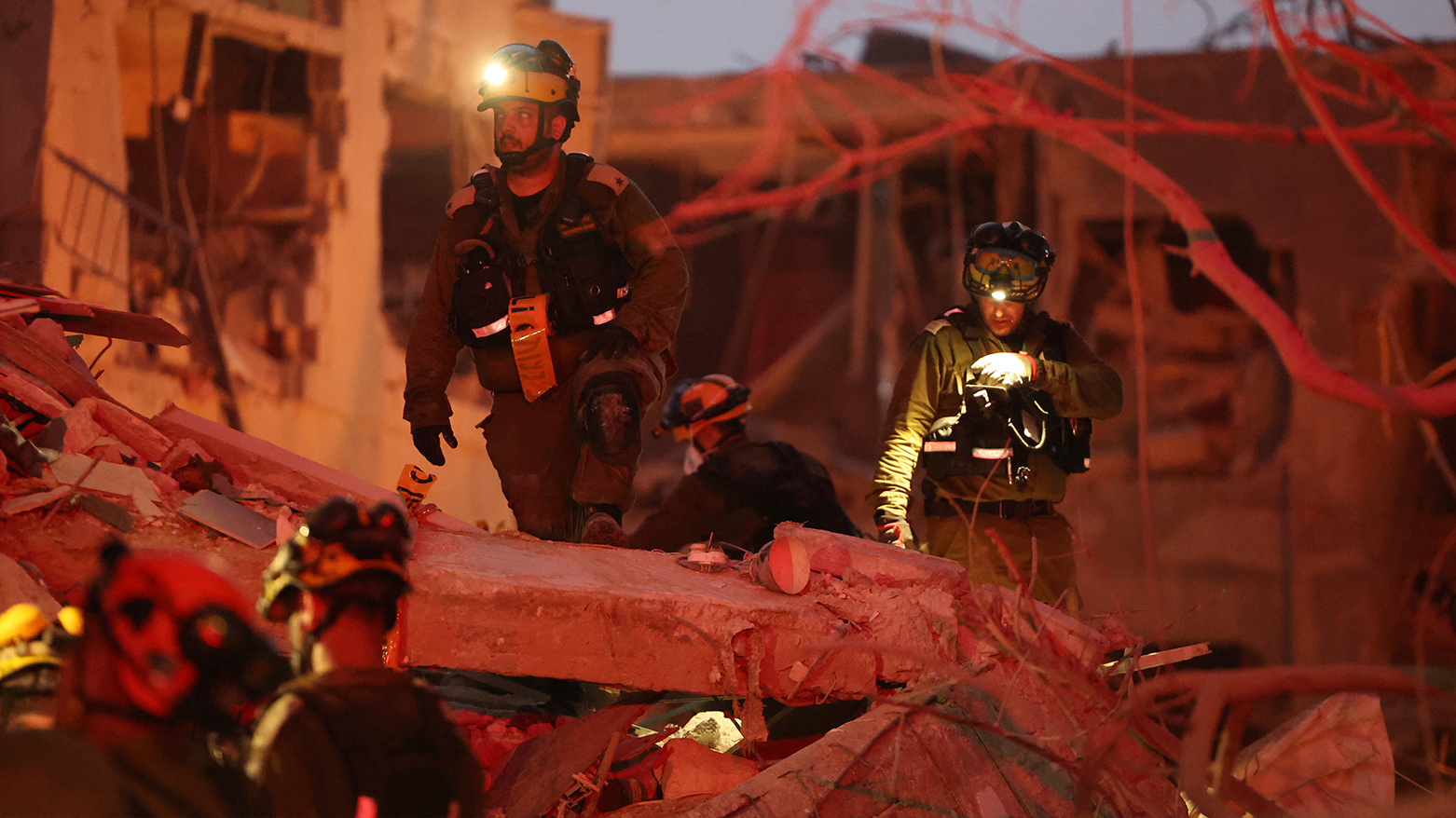Responders search through building rubble following a strike by an Iranian missile in the Israeli city of Bat Yam, south of Tel Aviv, early on June 15, 2025. (Photo: AFP)