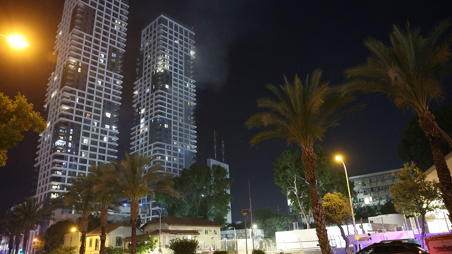 Smoke rises from a building, reportedly hit by a missile fired from Iran, in central Tel Aviv on June 13, 2025. (Photo: AFP)