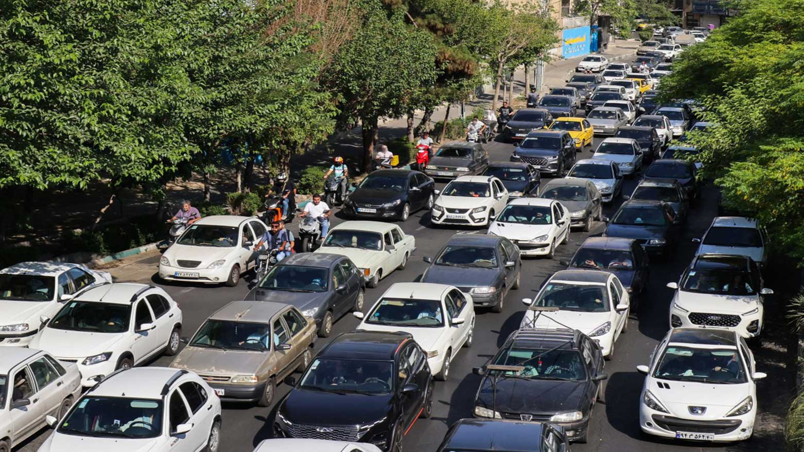 Vehicles await in traffic as people get out of Tehran through an artery in the city's west, June, 2025. (Photo: AFP)