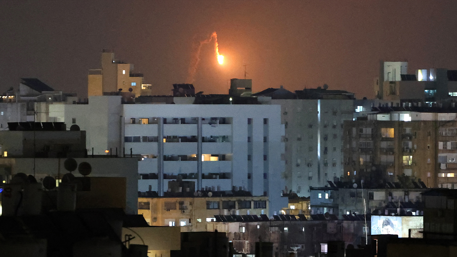 Rocket trails are seen in the sky above the Israeli coastal city of Netanya amid a fresh barrage of Iranian missile attacks on June 17, 2025. (Photo: AFP)