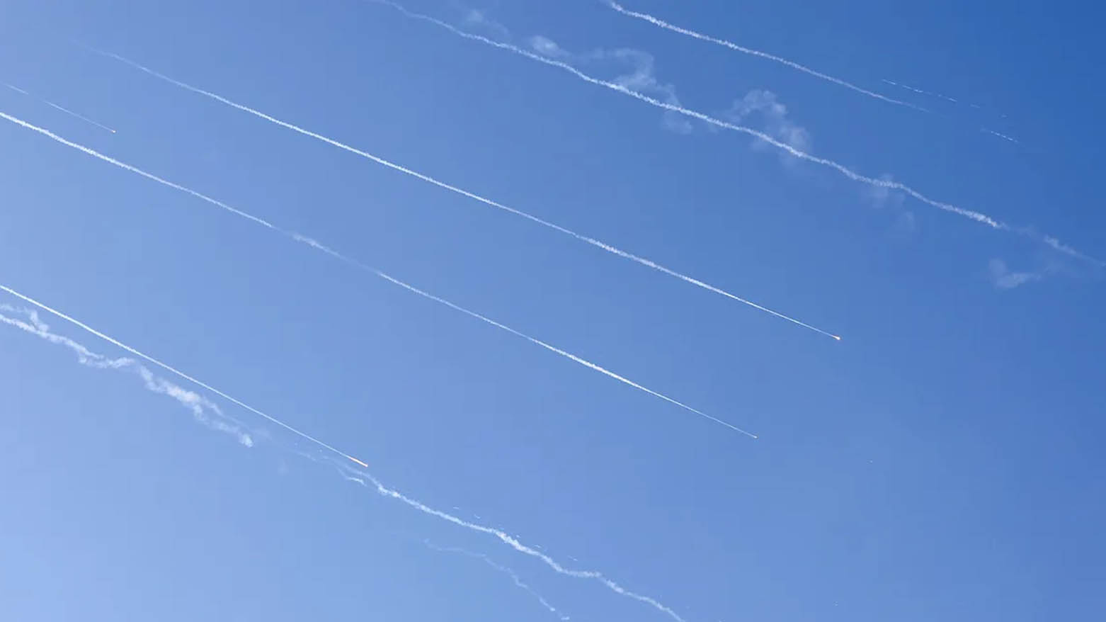 Rocket fragment trails are seen in the sky above the Israeli coastal city of Netanya amid a fresh barrage of Iranian missile attacks on June 19, 2025. (Photo: AFP)