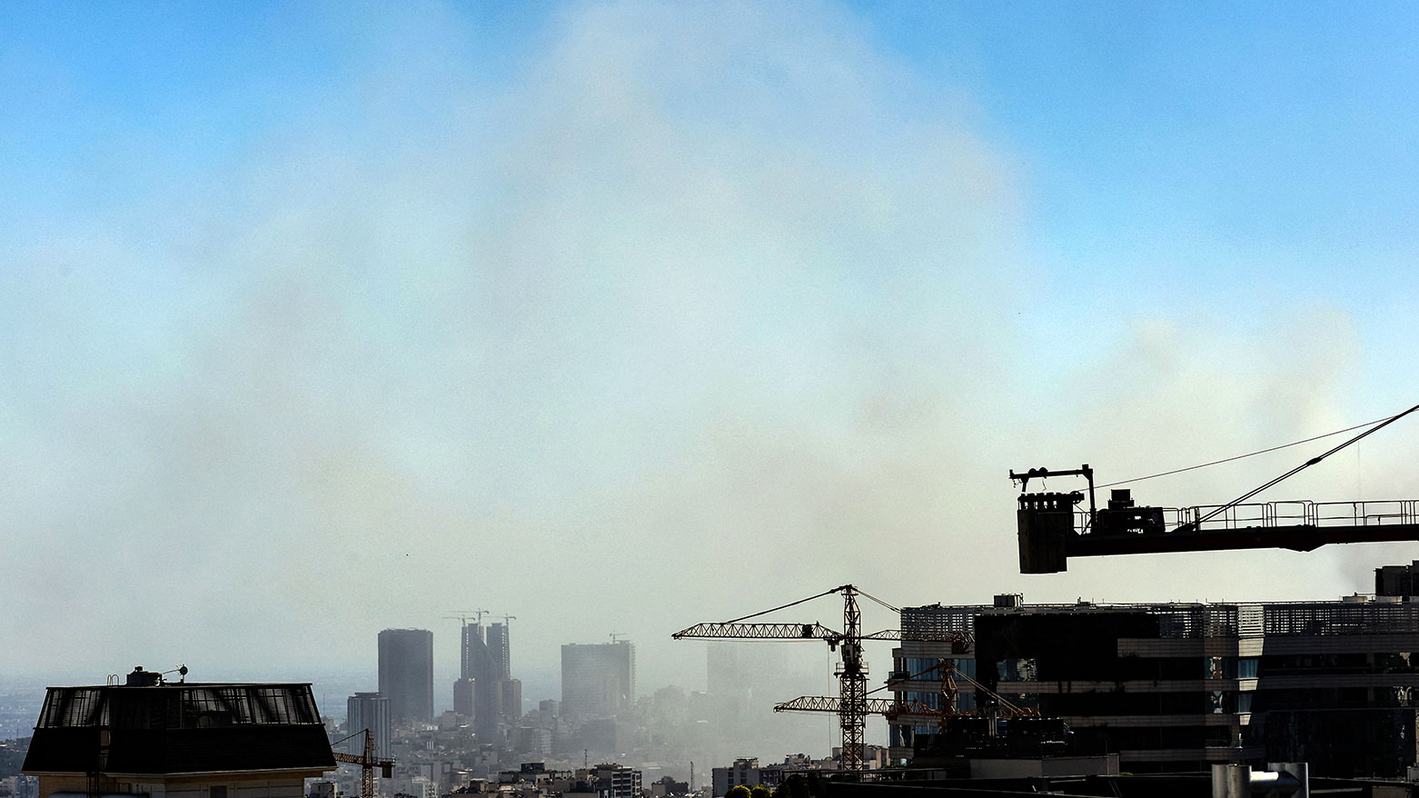 Smoke rises above buildings in Tehran following an Israeli strike on June 18, 2025. (Photo: AFP)