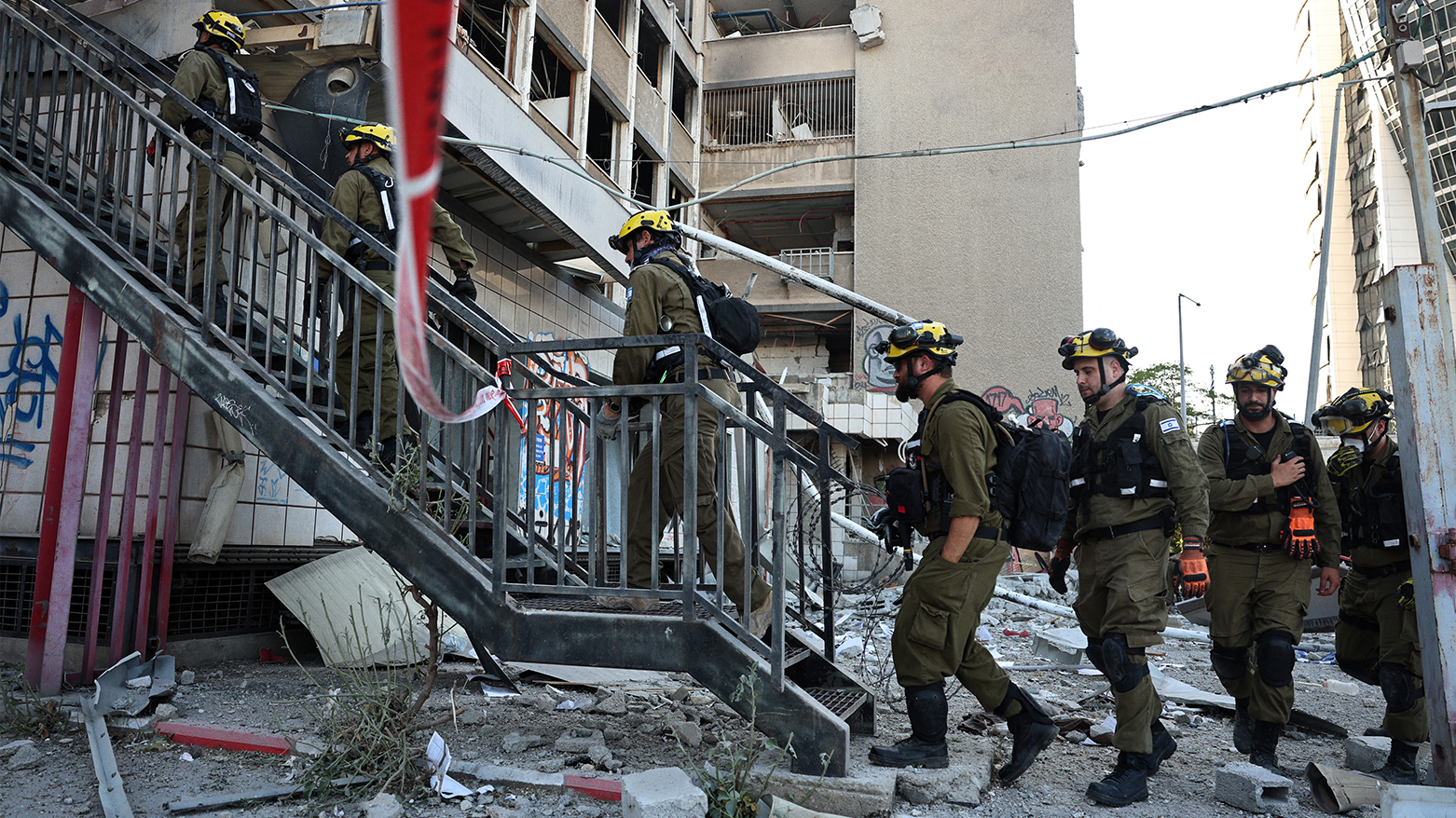 Israeli first responders enter a building that was hit by an Iranian strike in Haifa on June 20, 2025. (Photo: AFP)