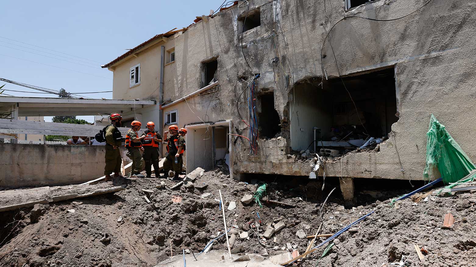 Israeli soldiers and first responders check the damage caused to a building from an Iranian strike in Beit She'an on June 21, 2025. (Photo: AFP)