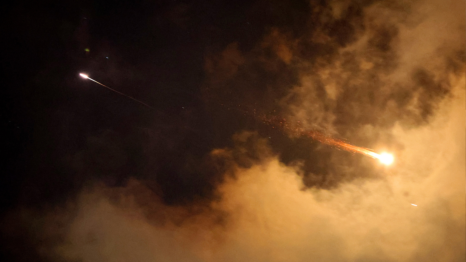 Rocket trails are seen in the sky above the Israeli coastal city of Netanya amid a fresh barrage of Iranian missile attacks on Jun. 21, 2025. (Photo: AFP)