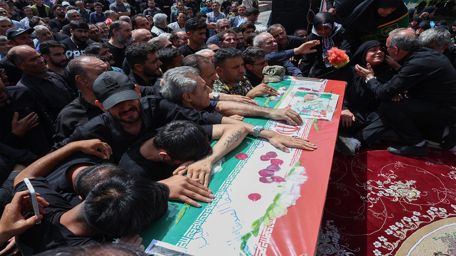 Iranians mourn over the flag-draped coffin of an Iranian soldier killed in an Israeli strike days ago, during his funeral procession in Tehran on Jun. 26, 2025. (Photo: AFP)