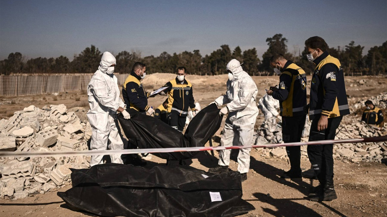 White Helmets transport body bags with remains from a mass grave in Damascus, Dec. 16, 2024. (Photo: AFP)