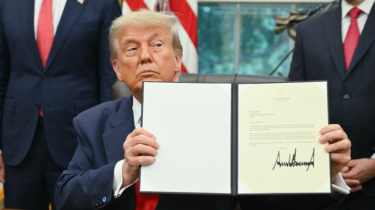 US President Donald Trump holds a letter addressed to Rwandan President Paul Kagame congratulating him on the peace agreement with Democratic Republic of the Congo, in the Oval Office of the White House in Washington, DC, on June 27, 2025. (Photo: AFP)