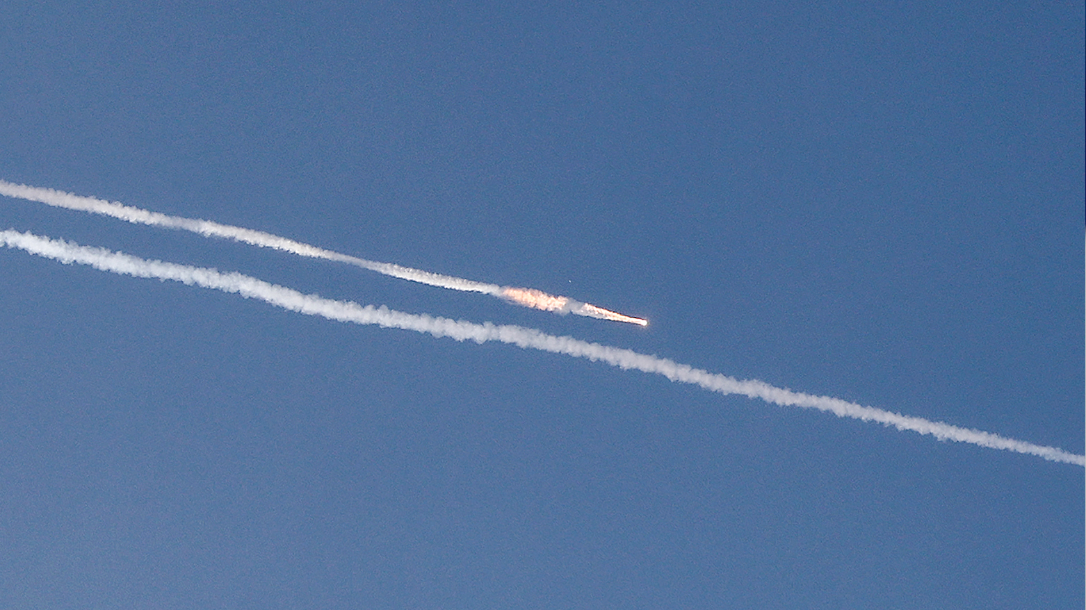 Rocket trails are seen in the sky above the Israeli coastal city of Netanya amid a fresh barrage of Iranian missile attacks on Jun. 24, 2025. (photo: AFP)