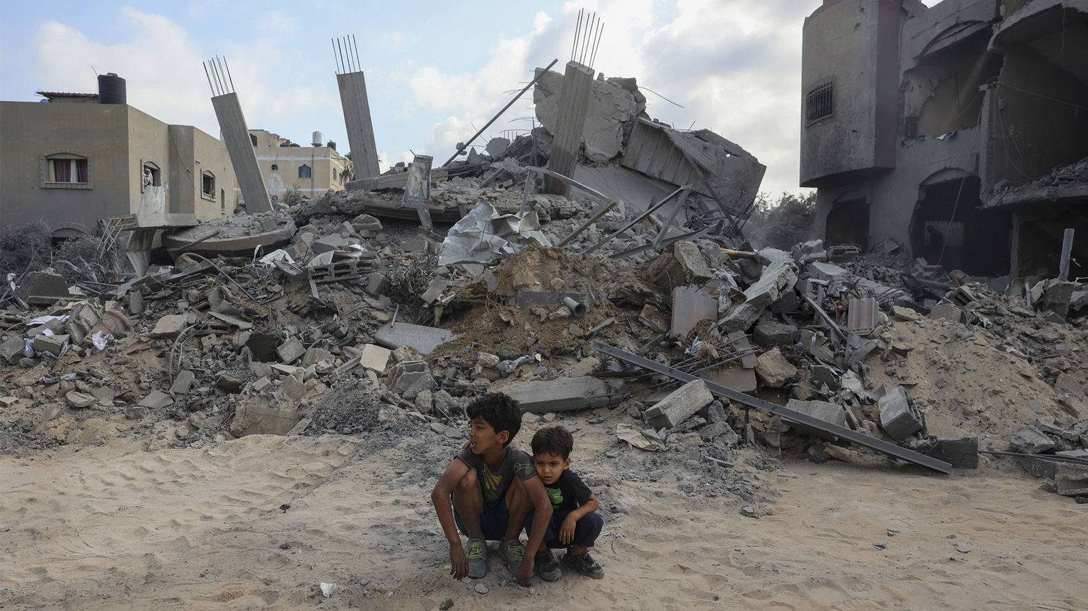 Children sit in front of a destroyed building in Nusseirat, Gaza Strip on Aug. 12, 2024. (Photo: AFP)