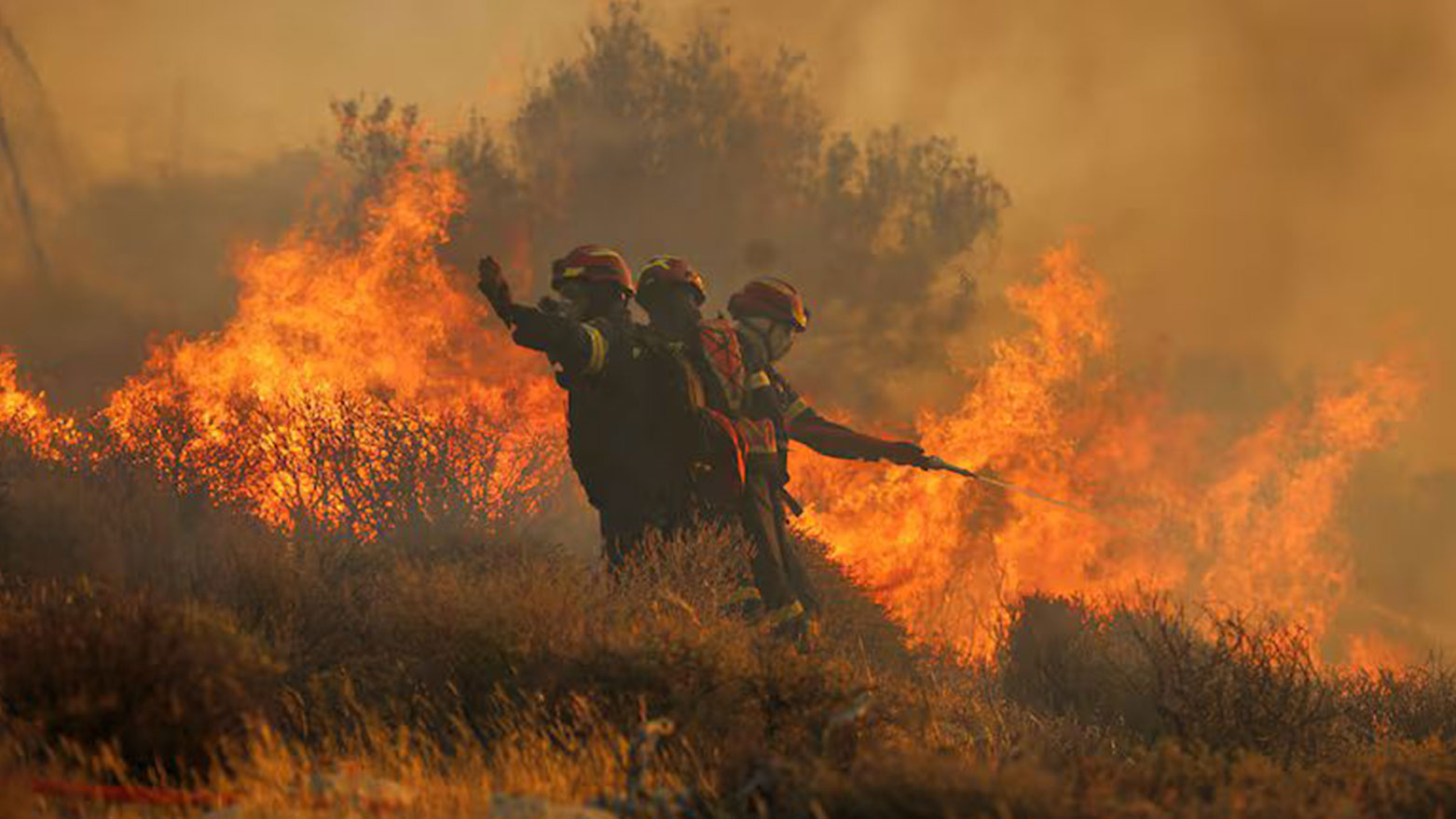 Firefighter uses a hose as the try to extinguish the blaze near the town of Ierapetra on the south coast of Crete island, Greece, July 3, 2025. (Photo: AP)