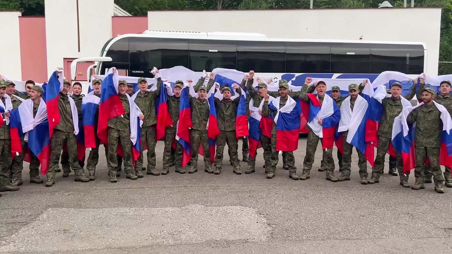اسرای جنگی روس که پس از تبادل زندانیان در بلاروس، با پرچم‌های ملی روسیه ژست گرفته‌اند. ۴ جولای ۲۰۲۵ - عکس:خبرگزاری فرانسه
