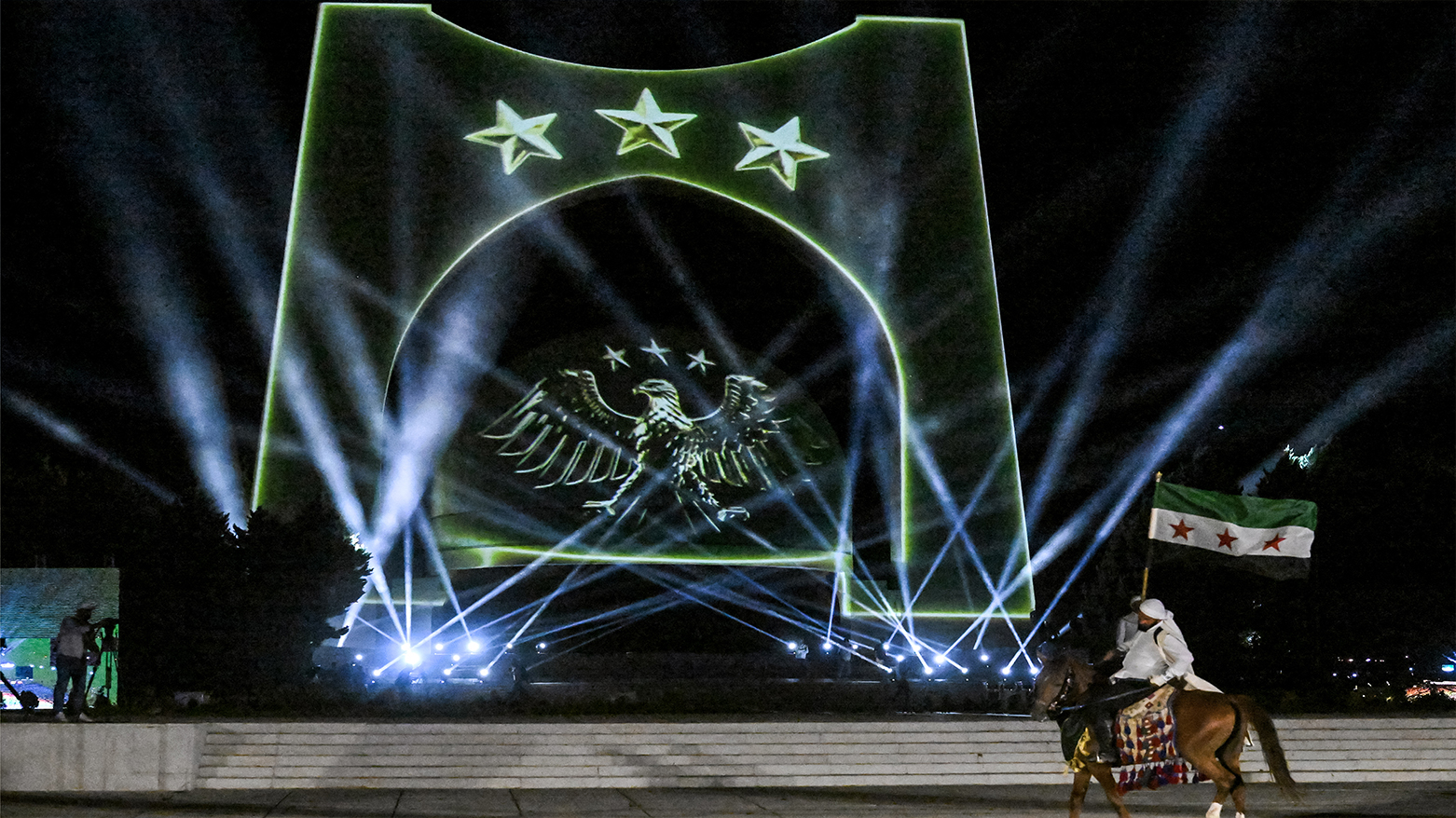 Horsemen perform during a ceremony unveiling Syria's new national emblem near the Tomb of the Unknown Soldier on Mount Qasioun overlooking the capital Damascus on Jul. 3, 2025. (Photo: AFP)