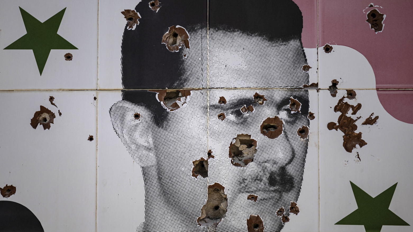 Bullet holes deface a mural depicting the toppled Syrian president Bashar al-Assad in Adra town on the northeastern outskirts of Damascus on Dec. 25, 2024. (Photo: AFP)