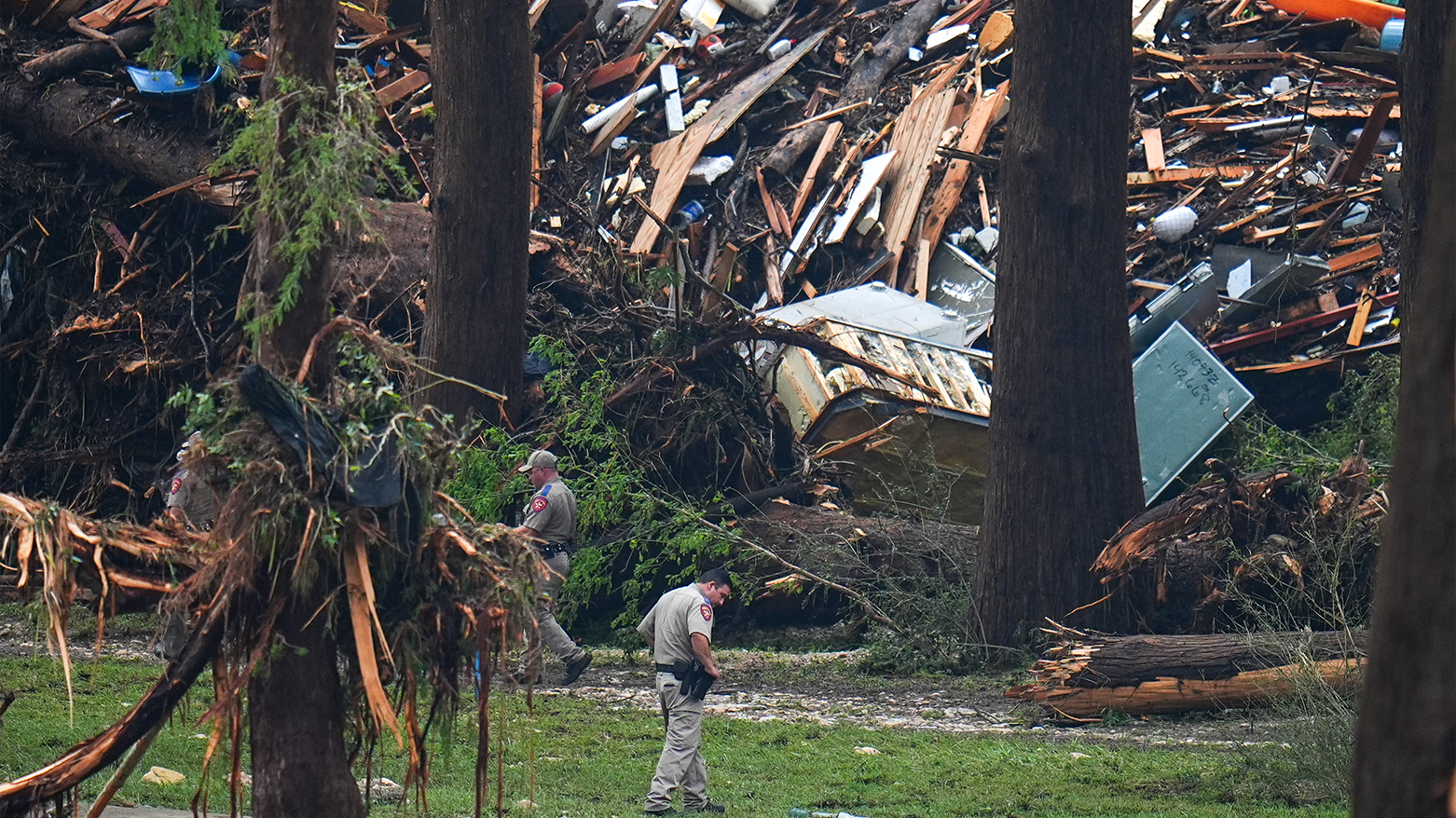 Officials comb through the banks of the Guadalupe River after a flash flood in Hunt, Texas. (Photo: AP)