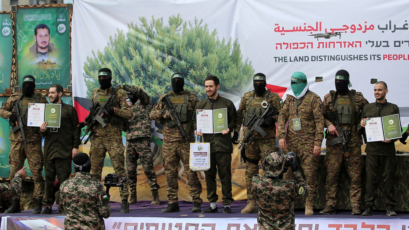 Hamas militants parade newly-released Israeli hostages (L to R) Elia Cohen, Omer Shem Tov and Omer Wankert on stage in Nuseirat in the central Gaza Strip, as part of the seventh hostage-prisoner release on Feb. 22, 2025. (Photo: AFP)