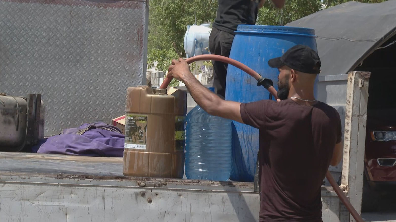 A young man from Baghdad fills water containers due to the lack of water in his area. (Photo: Kurdistan24)