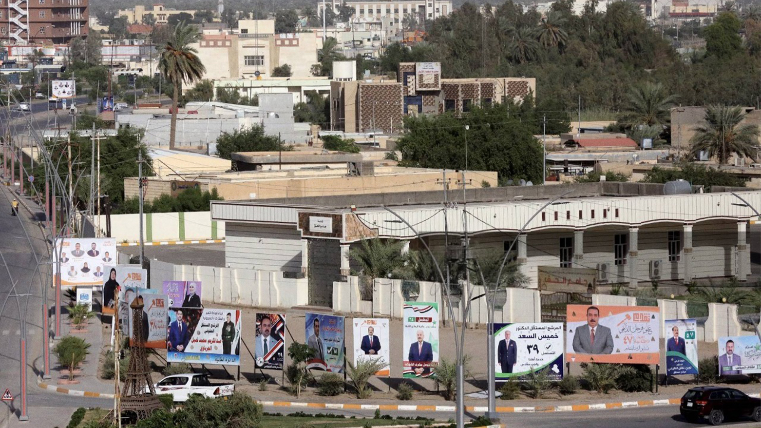 Campaign billboards for Iraq’s Oct. 2021 elections outside a mosque in Ramadi, Anbar province. (Photo: AFP)
