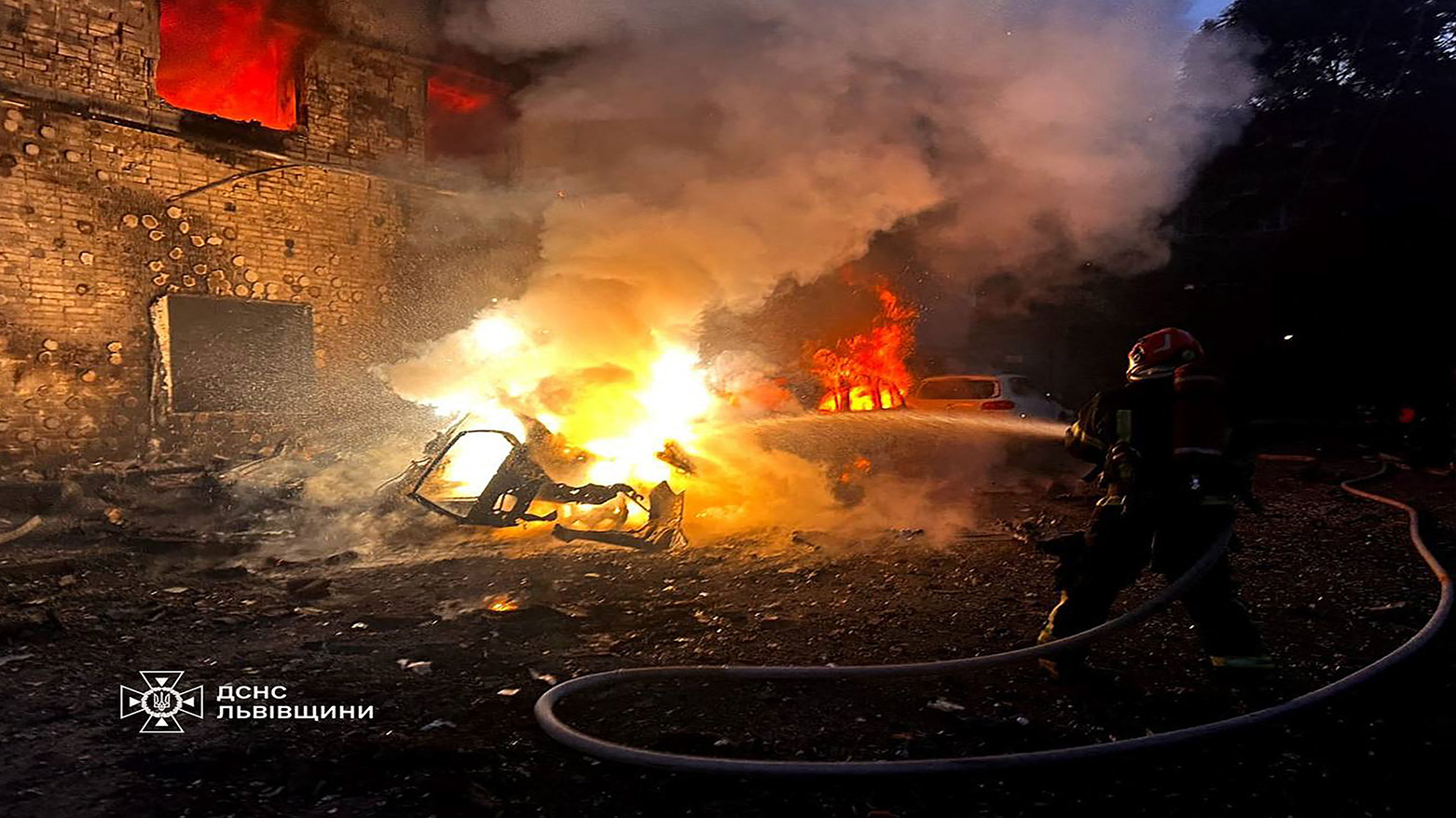 The Picture shows a firefighter dousing a burning car following mass Russian strikes in the western Ukrainian city of Lviv, amid the Russian invasion of Ukraine, on Jul. 12, 2025. (Photo: AFP)