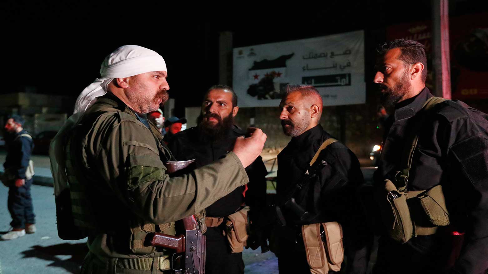 A Druze gunman, left, speaks with Syrian security forces, in Damascus, Syria, May 2, 2025. (Photo: AP)