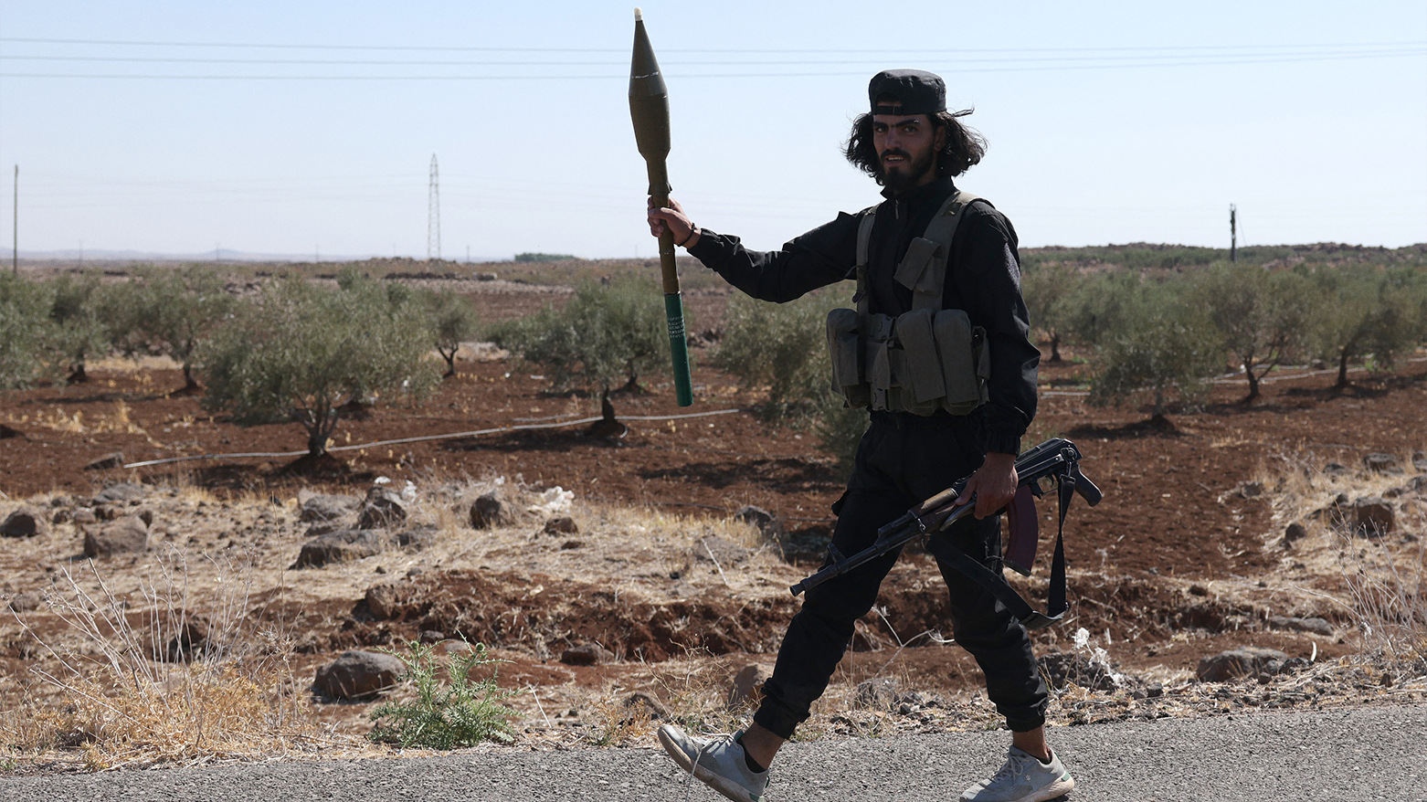 A member of the Syrian security forces walks down a road in the Mazraa area, near Suwayda on July 14, 2025. (Photo: AFP)