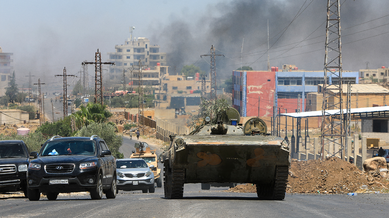 Members of Syria's security forces drive through the predominantly Druze city of Sweida on July 15, 2025. (Photo: AFP)
