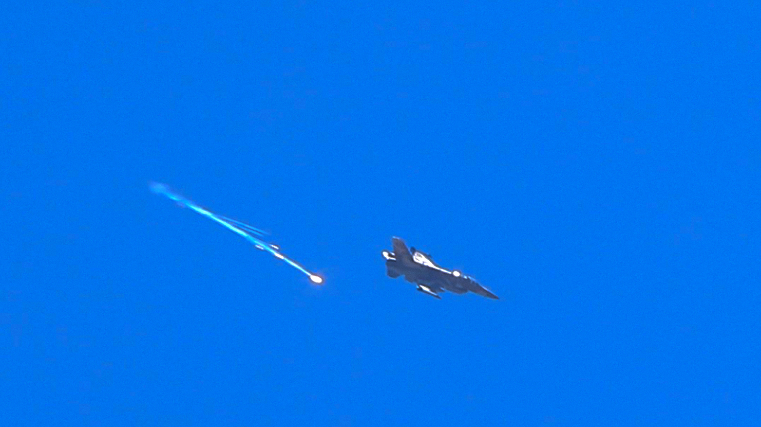 An Israeli fighter aircraft fires a flare as it flies over the predominantly Druze city of al-Suwayda on July 15, 2025. (Photo: AFP)