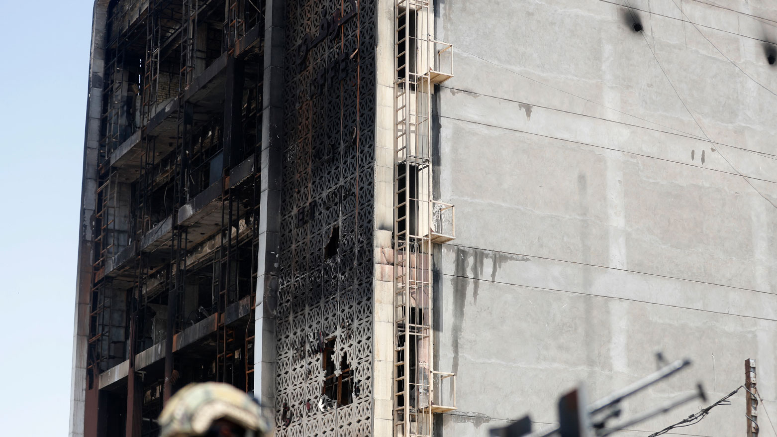 In front of the damaged shopping mall after a fire tore through the newly opened Hyper Mall overnight in the eastern Iraqi city of Kut, July 17, 2025. (Photo: AFP)