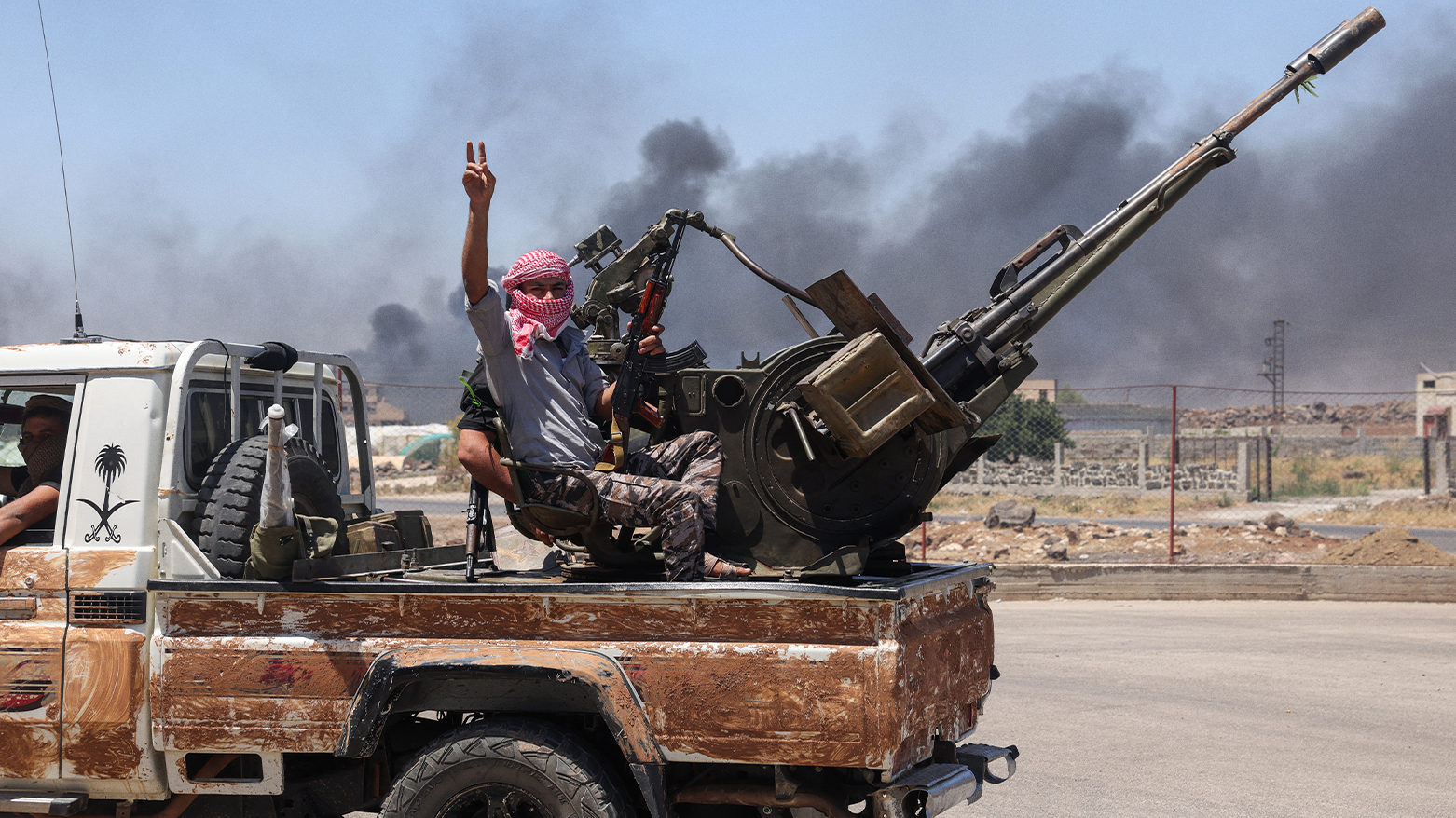 Bedouin and tribal fighters deploy at the western entrance of Syria's Druze heartland of al-Suwayda on July 18, 2025. (Photo: AFP)