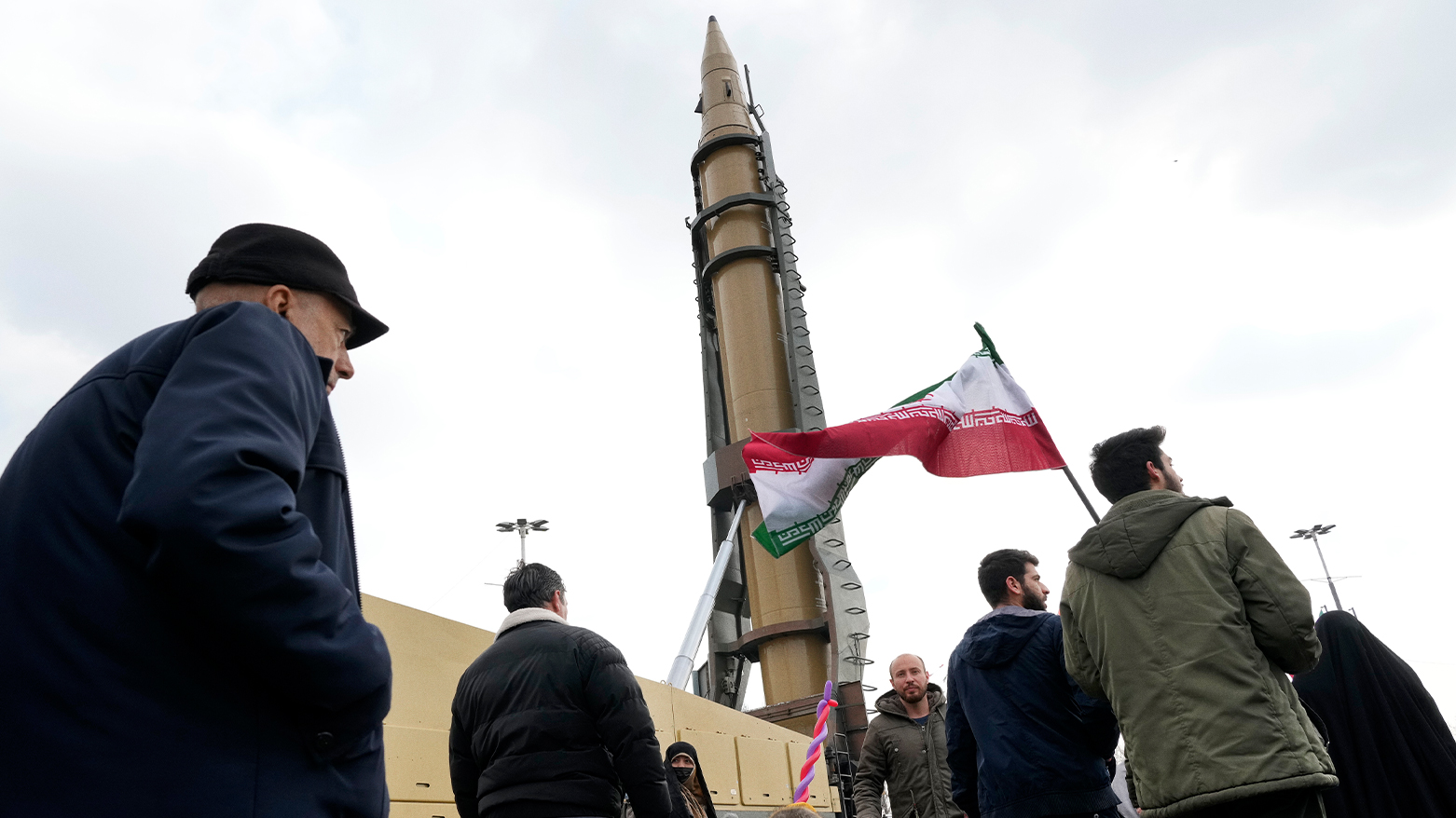 Iranian demonstrators march next to a domestically-built missile. (Photo: AP)