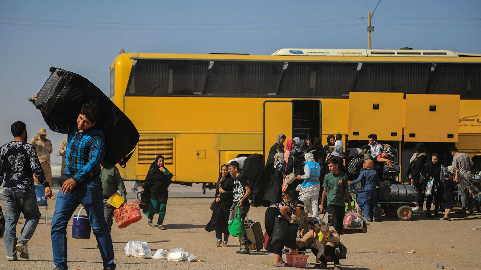An Iranian bus drops off Afghan refugees at Zero Point on the Islam Qala border in Herat Province on July 24, 2025. (Photo: AFP)