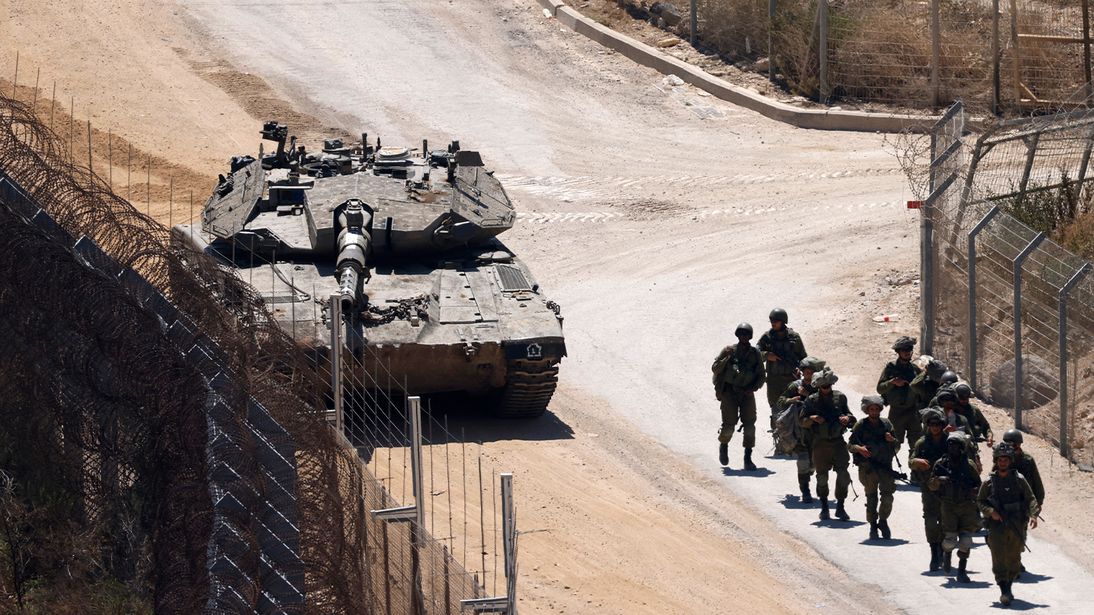 Israeli troops patrol the border fence with Syria near the Druze village of Majdal Shams in the Israel-annexed Golan Heights on July 23, 2025. (AFP)
