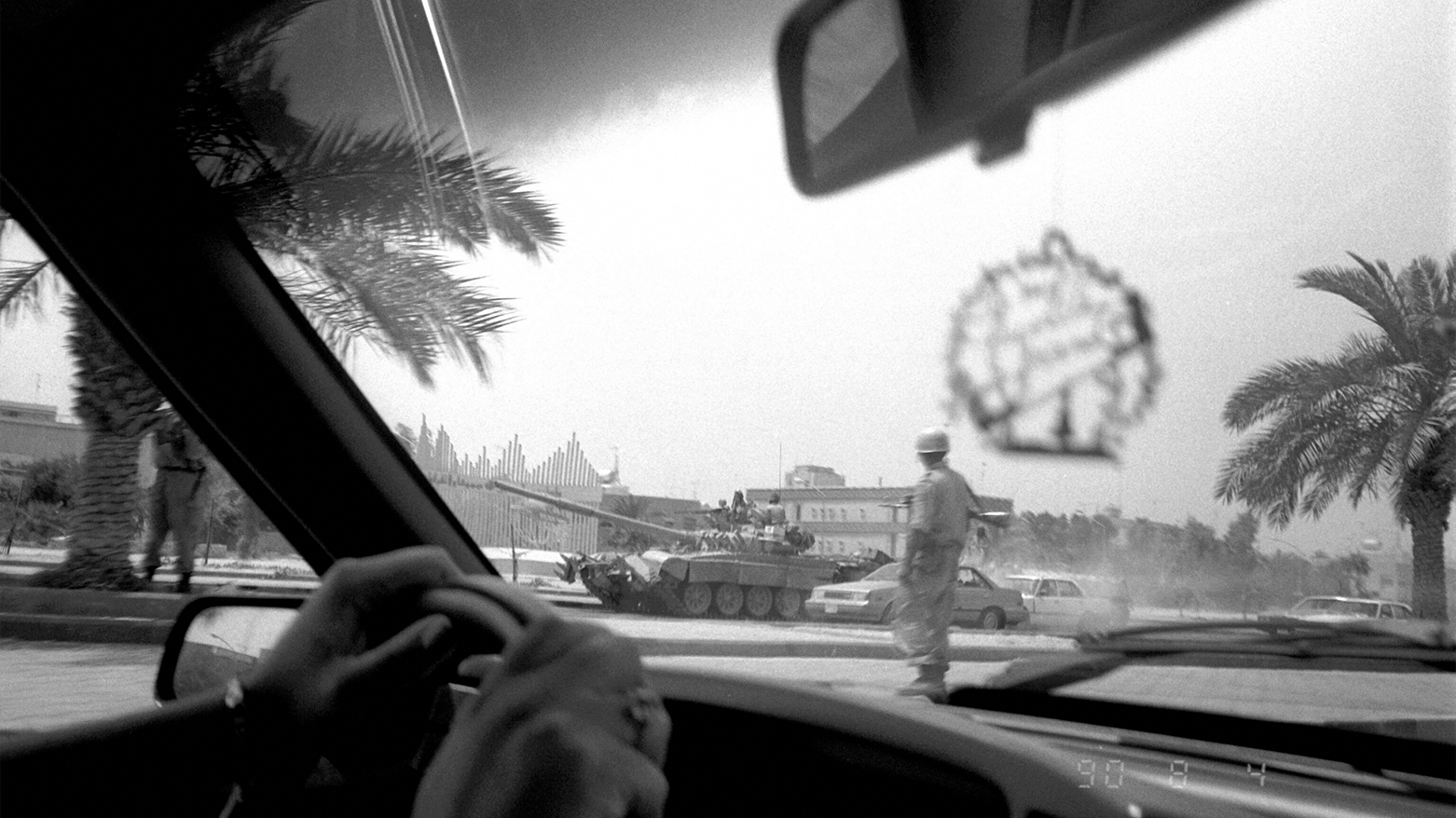 Iraqi soldiers atop a tank patrol Kuwait City streets on August 4, 1990, two days after the invasion, seen from a passing car. (AP)