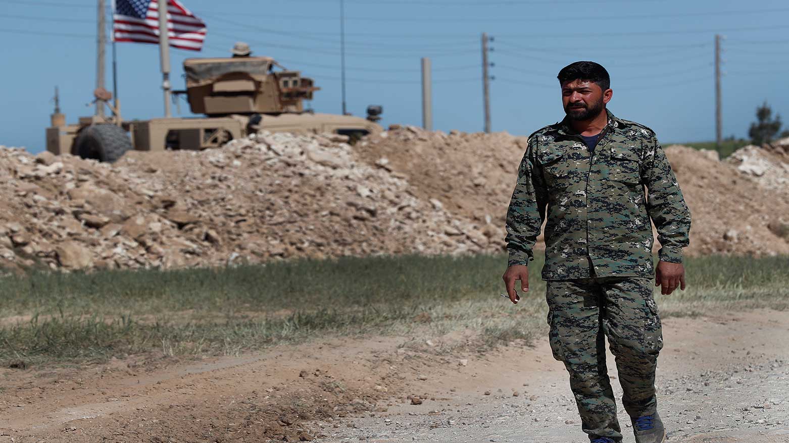 In this April 4, 2018 file photo, a U.S-backed Syrian Manbij Military Council soldier passes a U.S. position, in Manbij, north Syria.. (Photo: AP)
