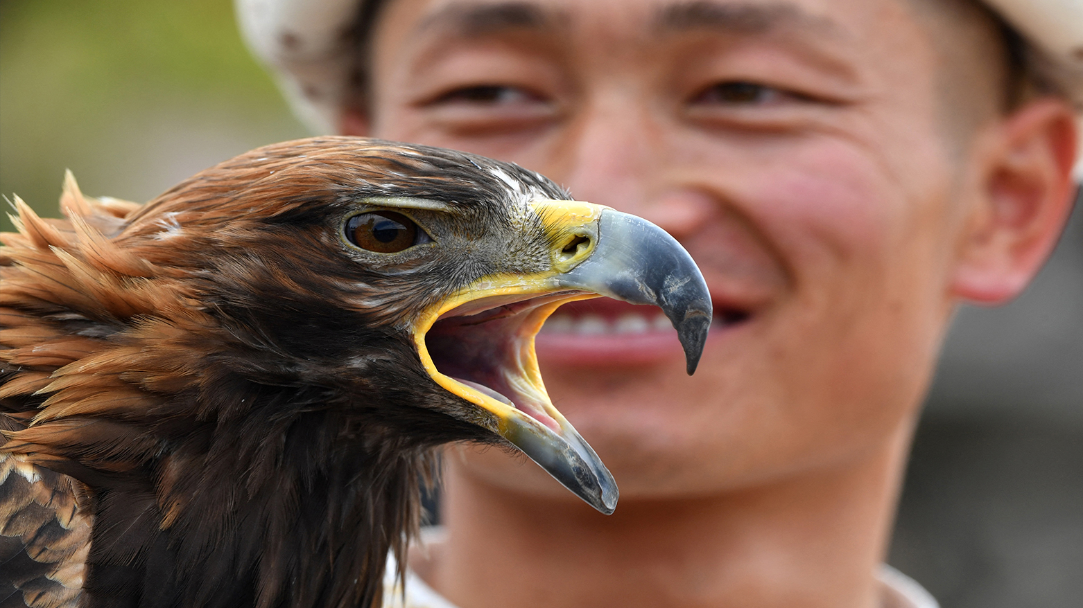 A Kyrgyz "berkutchi" (an eagle hunter) holds his golden eagle, during the hunting festival "Salburun", in the village of Bokonbayev, near Lake Issyk-Kul, on August 2, 2025. (Photo: AFP)