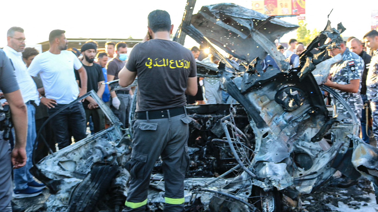 Members of the Lebanese police and civil defence check a car after it was hit by a reported Israeli strike in the Masnaa area in eastern Lebanon on August 7, 2025. (AFP)