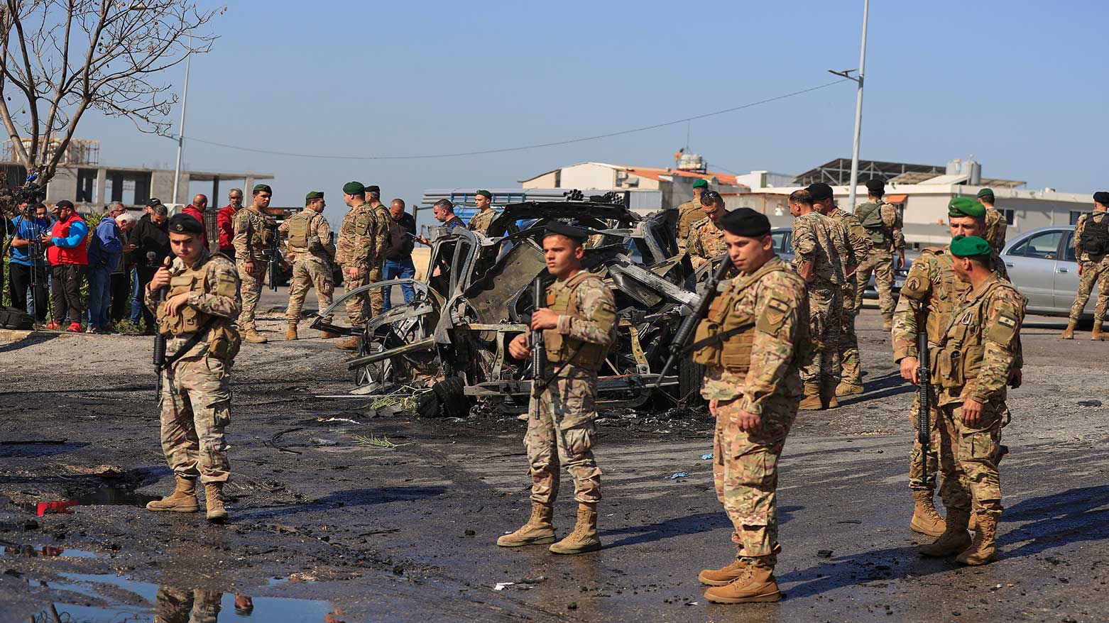 Lebanese army soldiers gather near a charred car that was hit by an Israeli strike, in the southern coastal town of Ghazieh, Lebanon, April 18, 2025. (Photo: AP)