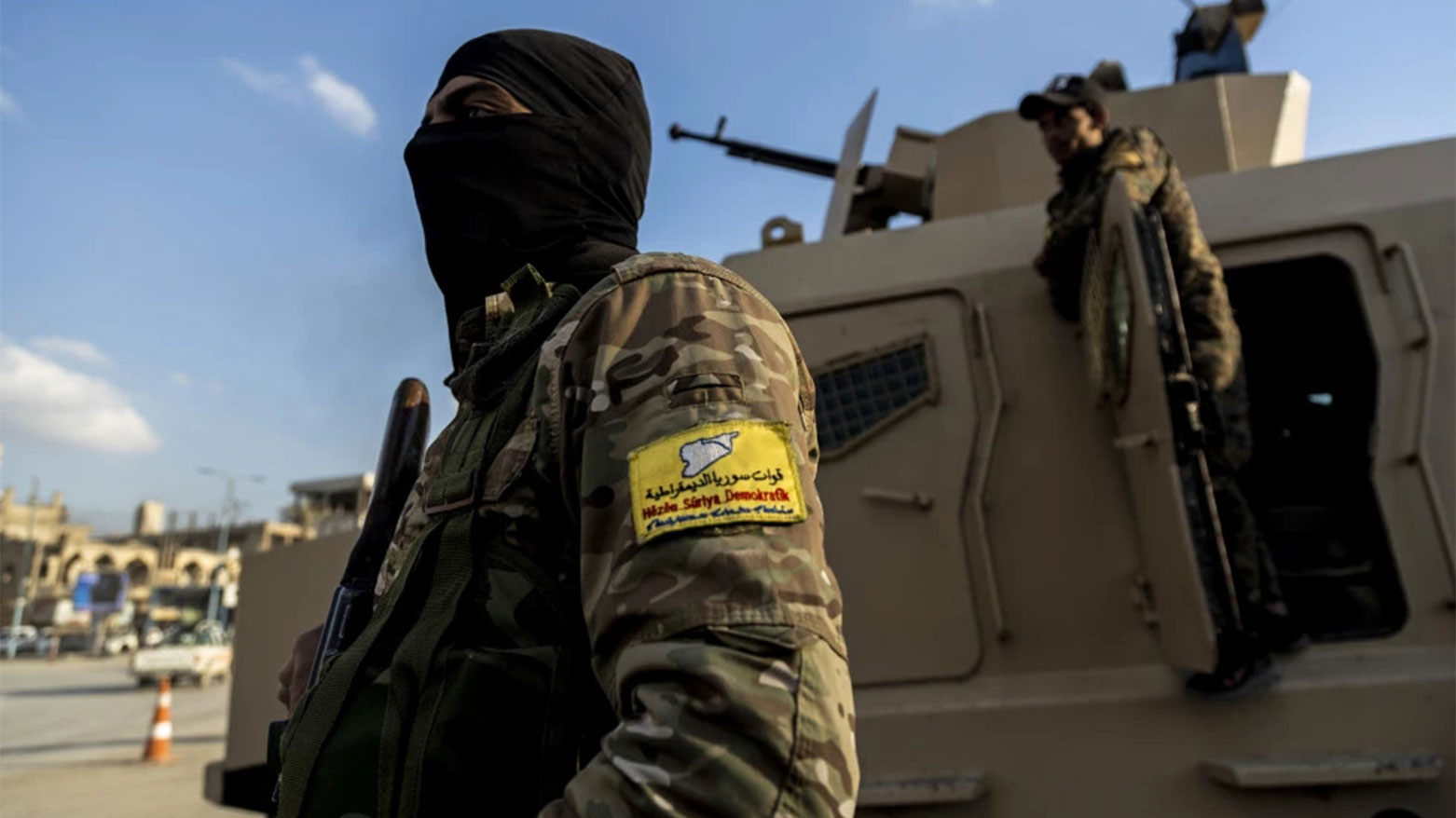 U.S.-backed Syrian Democratic Forces (SDF) fighters stand guard at Al Naeem Square, in Raqqa, Syria, Monday, Feb. 7, 2022. (AP)