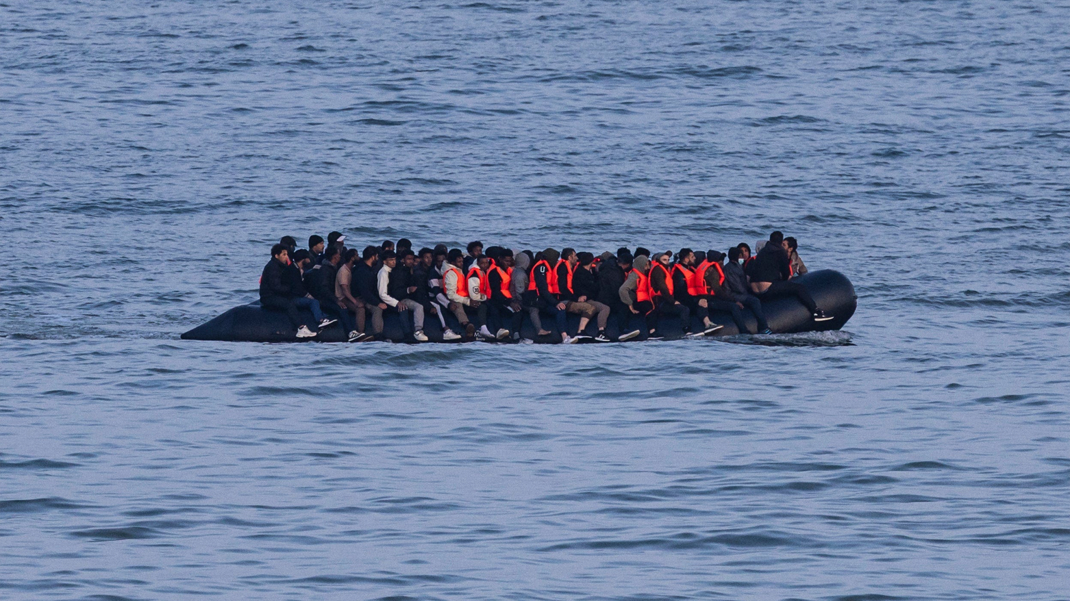 Migrants sail onboard a smuggler's boat in an attempt to cross the English Channel off the beach of Neufchatel-Hardelot, northern France on June 18. (AFP)