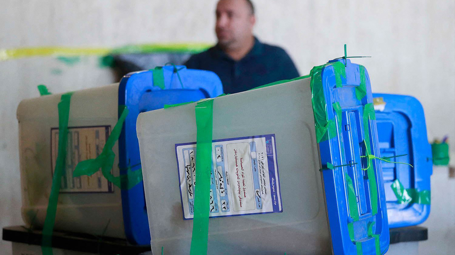 An employee stands by ballot boxes in the capital Baghdad on November 23, 2021. (AFP)