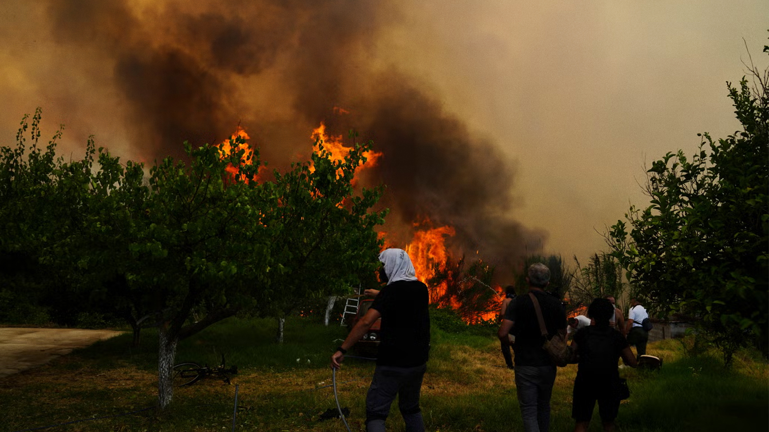 People try to control a wildfire in Vounteni, on the outskirts of Patras, western Greece, Wednesday, Aug. 13, 2025. (AP)