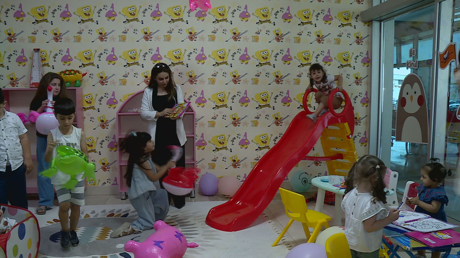 Several children playing in a colorful indoor play area at Erbil residence building. (Photo: Kurdistan24)