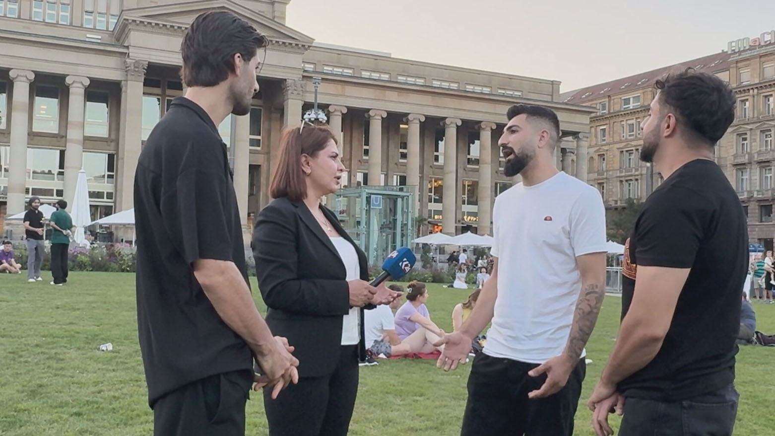 Kurdistan24 correspondent Awara Hawrami (C) talking with Kurdish asylum seekers in Stuttgart. (Photo: Kurdistan24)