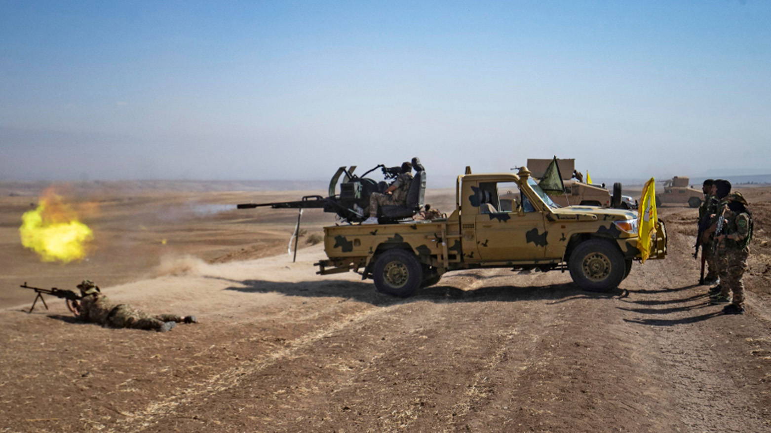A fighter of the Syrian Democratic Forces (SDF) fires the turret of a technical vehicle with forces of the US-led coalition, in Syria's northeastern (Western Kurdistan) Hasakah province on Sep. 7, 2022. (AFP)