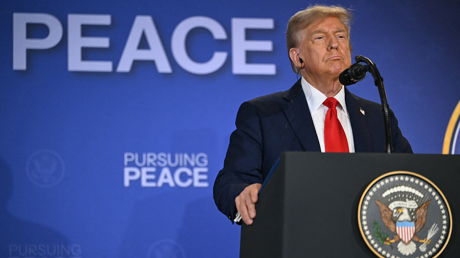 US President Donald Trump listens during a joint press conference with Russian President Vladimir Putin, in Alaska, on Aug. 15, 2025. (AFP)