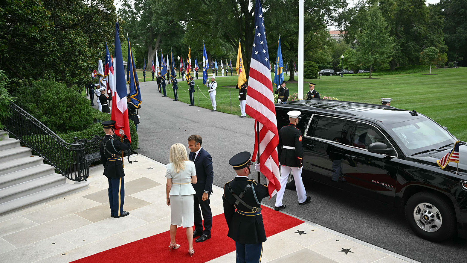 French President Emmanuel Macron is greeted by US Chief of Protocol Monica Crowley (L) upon arrival at the White House South Portico in Washington, DC, on August 18, 2025. (Photo: AFP)
