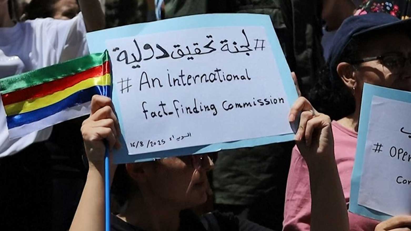 A Druze girl in Syria’s Sweida province holds a sign demanding an international probe into government atrocities, Aug. 16, 2025. (Photo: AFP)
