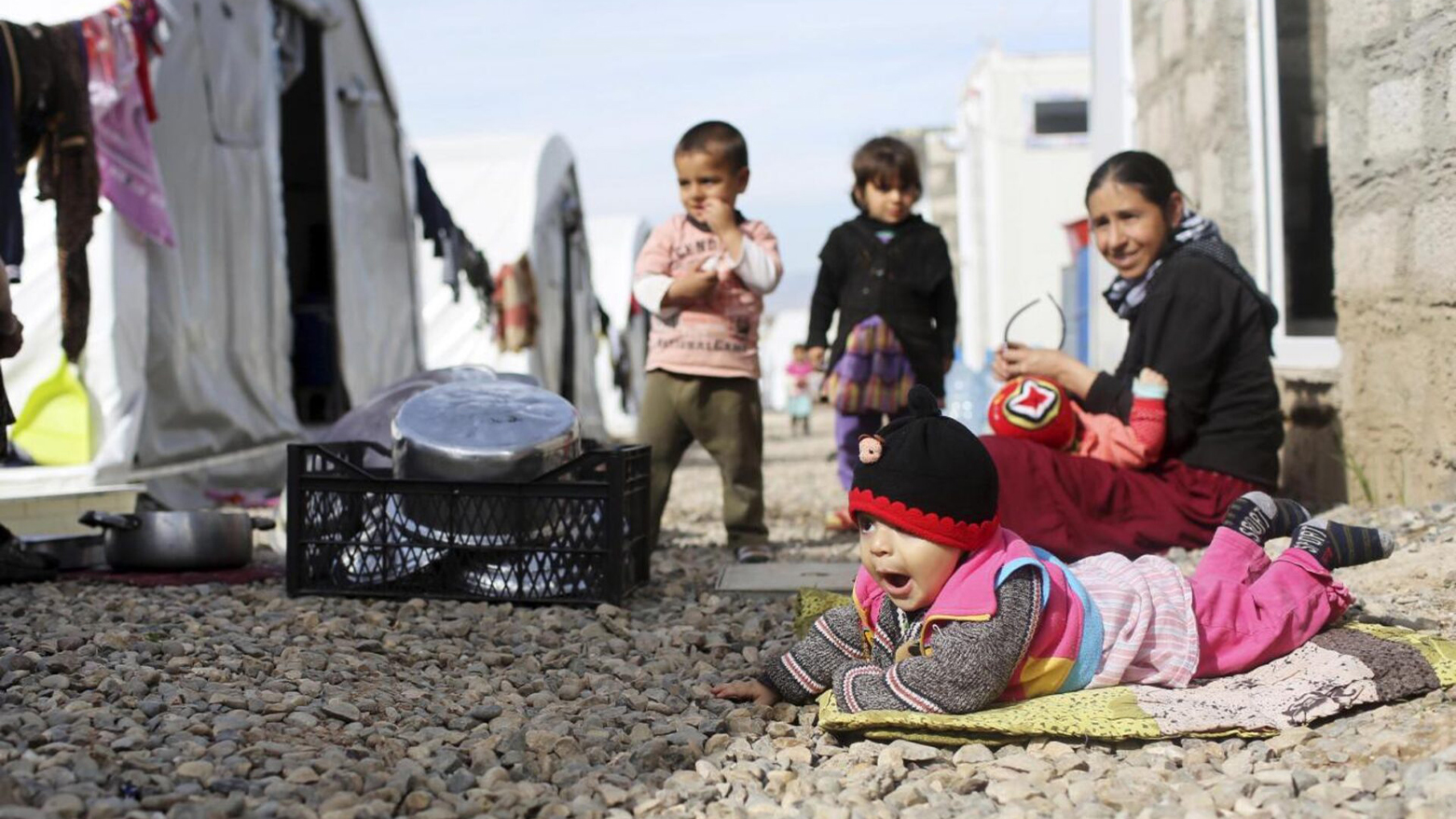 Yazidi children stand outside their tent at a refugee camp near Duhok, Feb. 27, 2015. (Reuters)