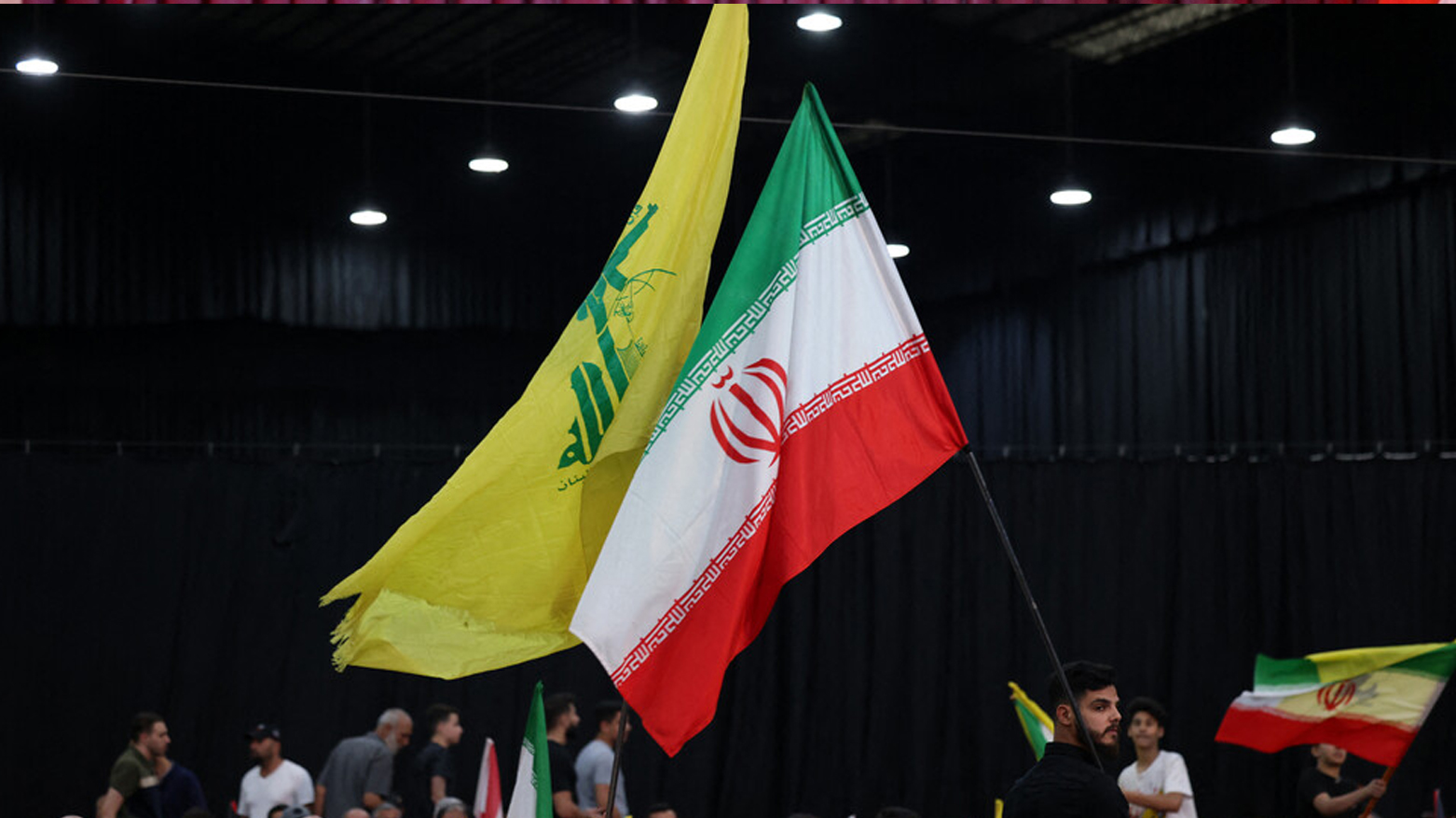 Protesters carrying Iranian and Hezbollah flags. (Photo: Social Media)